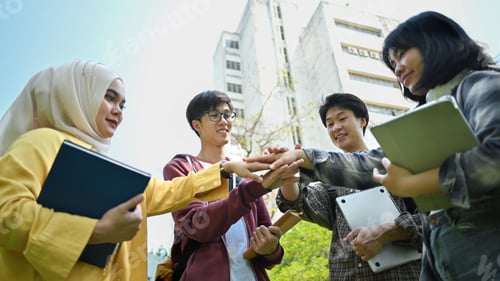 Preview: Low angle view of university students join hand together. Human relationship concept.