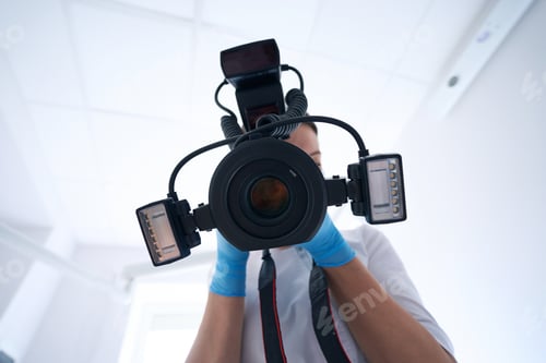 Preview: Professional stomatologist taking dental images with digital camera