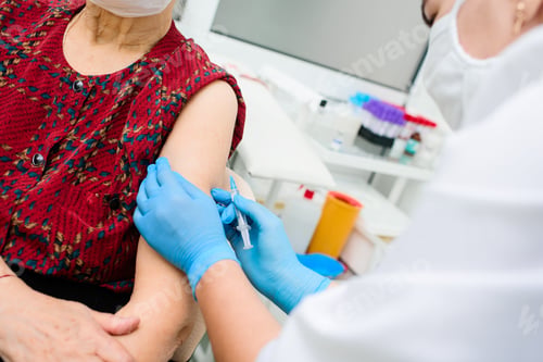 Preview: nurse giving an injection to an elderly woman