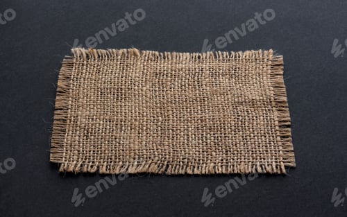Preview: Old burlap fabric napkin on black background