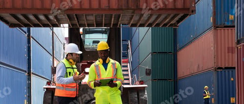 Preview: Industrial Engineer checking inventory or task details at Container cargo harbor.