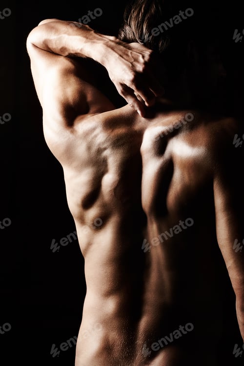 Preview: Masculinity in portrait. Studio shot of a muscular shirtless man isolated on black.