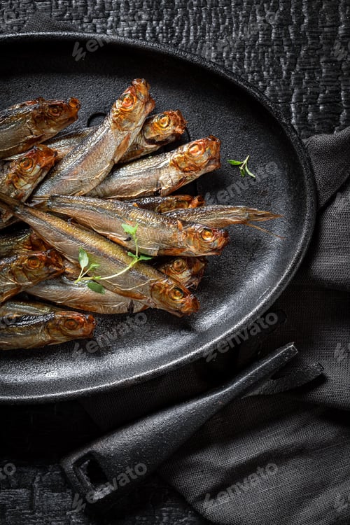 Preview: Tasty smoked sprats with herbs and salt.