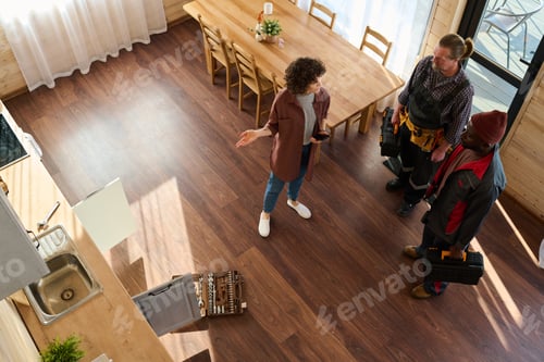 Preview: Above angle of young housewife complaining about problem with faucet