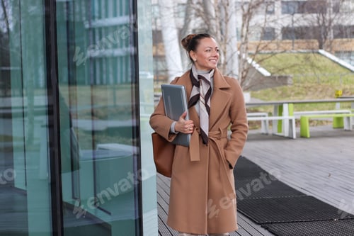 Preview: A young confident business woman with laptop. Using technology.Business professionals.