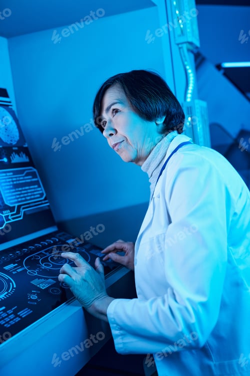 Preview: Futuristic Expertise: Senior Woman Scientist Engaged Near Computer in Future Science Center