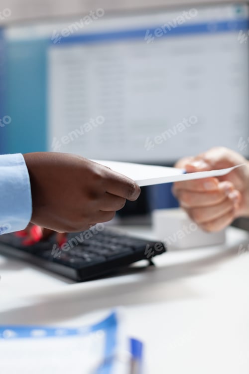 Preview: Closeup of african american physician doctor giving document with medication prescription