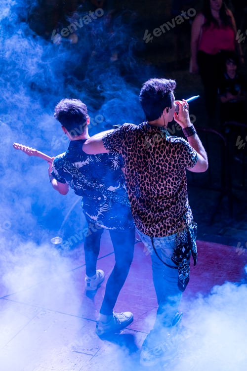 Preview: Rock and roll group performing live at night