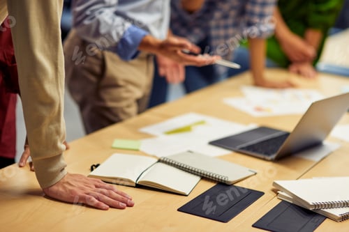 Preview: Cropped short of a business people using laptop while working together in the office