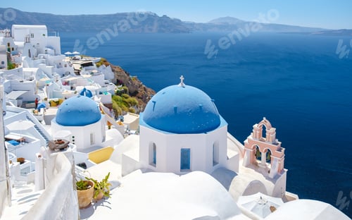 Preview: White churches an blue domes by the ocean of Oia Santorini Greece, traditional Greek village