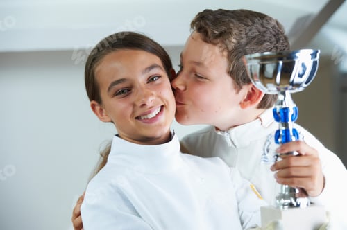 Preview: Boy kissing smiling fencing rival