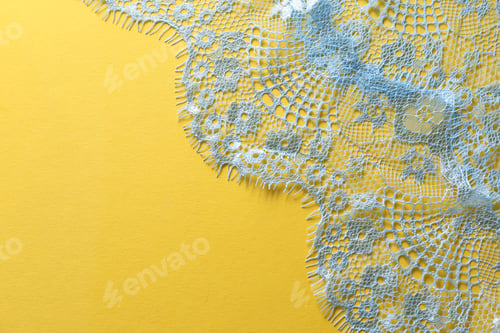 Preview: Light blue lace on yellow background, top view. Space for text