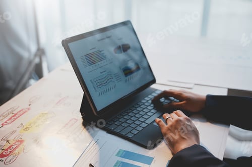 Preview: Businesswoman is analyzing financial data on a tablet