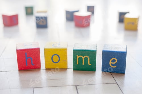 Preview: Colorful blocks spelling out HOME on a bright floor