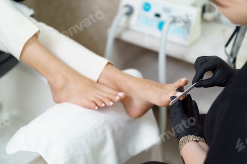 Preview: Woman making pedicure in beauty salon