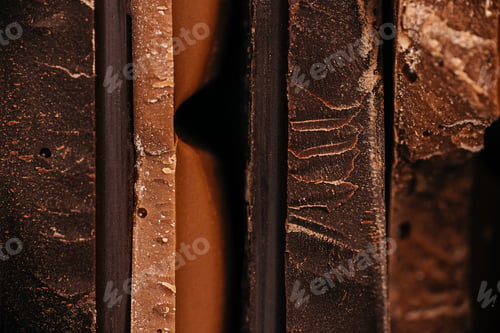 Preview: Close-up macro view of assorted chocolate bar edges with layered textures