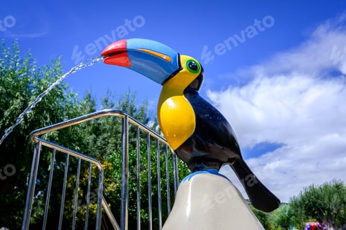 Preview: Water fountain shaped like a toucan, tropical bird, in a water park.