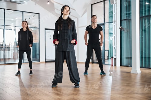 Preview: Trainer with students meditating in standing position