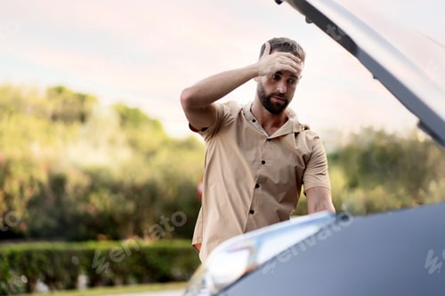Preview: Driver having engine problem standing near broken car on the road. Car breakdown concept