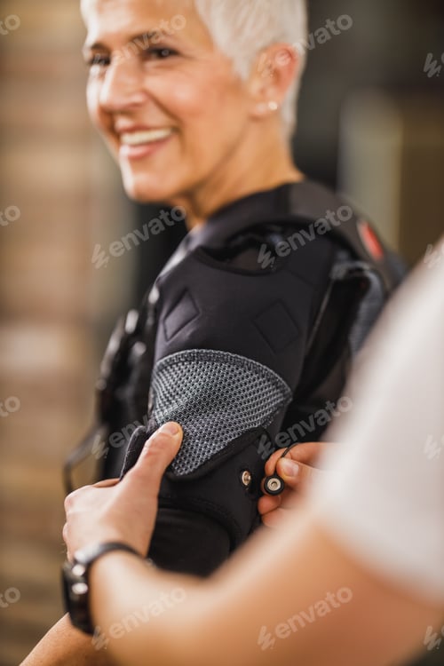 Preview: Fitness Instructor Putting An Ems Suit To A Woman