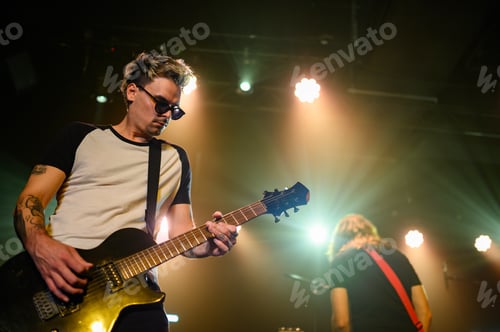 Preview: Guitarist playing electric guitar on stage during concert