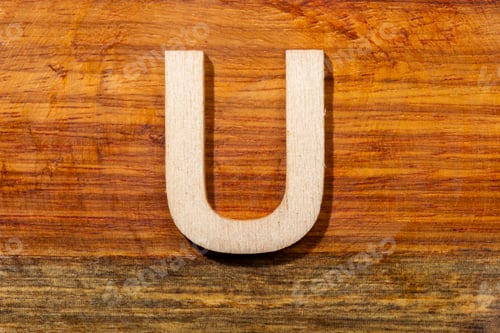 Preview: Wooden letters U on wooden background, top view