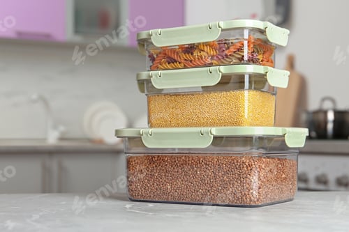 Preview: Stacked boxes with different food on table in kitchen, space for text