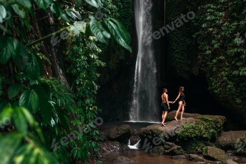 Preview: A couple in love on a waterfall. Honeymoon trip. Happy couple on the island of Bali