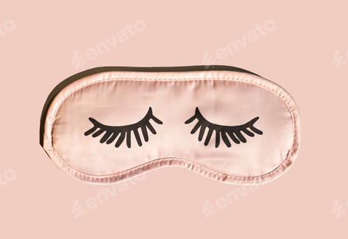 Preview: Pink mask for sleeping with eyelashes on a pink background.