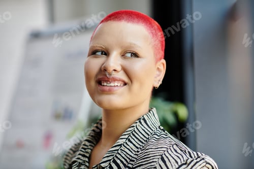 Preview: A bald woman with bright red hair smiles cheerfully in a stylish outfit, radiating confidence