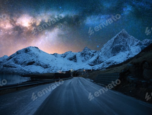 Preview: Milky Way over road, snowy mountains at winter starry night