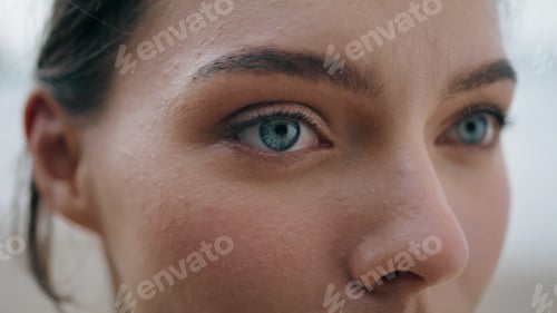Preview: Green eyes girl face looking far away close up. Portrait of sensual woman posing