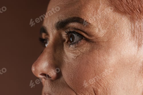 Preview: Senior ginger woman with short hair posing and looking aside