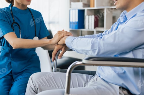 Preview: Female doctor is giving physical therapy advice to a male patient in a wheelchair.