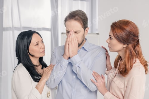 Preview: multiethnic women supporting depressed middle aged man during group therapy