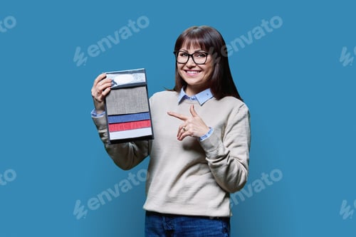 Preview: Woman holding samples of fabrics for interior, on blue background