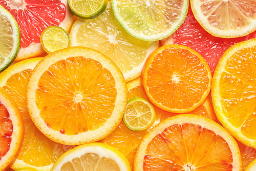 Preview: Slices of fresh citrus fruits as background, top view