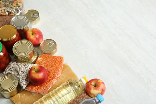 Preview: Many different products and space for text on white wooden background. Food donation