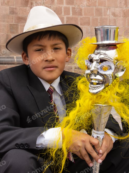 Preview: Peru - January, 02 2012: Schoolboy with fancy staff looking at camera