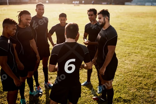 Preview: Cropped shot of a diverse group of sportsmen standing together before playing rugby during the day