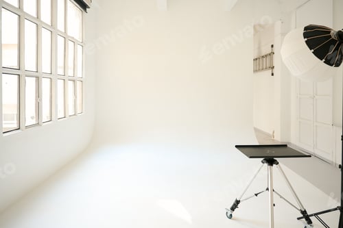 Preview: Empty photo studio with lighting equipment and large window