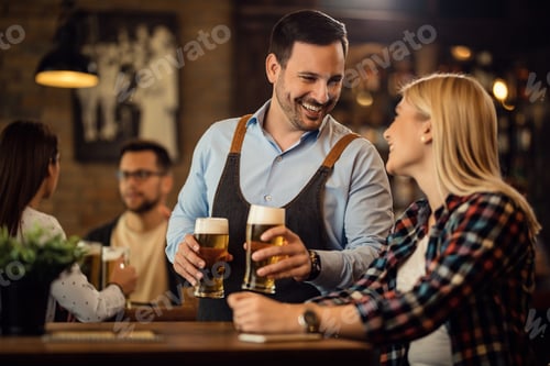 Preview: Happy waiter talking to a woman while serving her a beer in a pub.