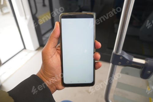 Preview: young man hand using smart phone with green screen inside of metro train