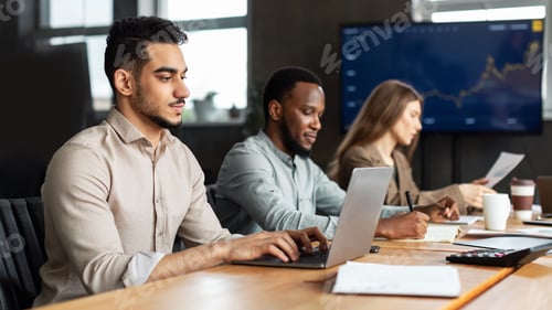 Preview: Successful male manager using laptop, typing on keyboard
