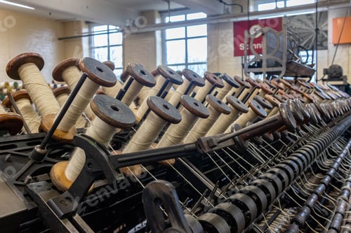 Preview: the interior of a knitting factory filled with lots of spooling spools
