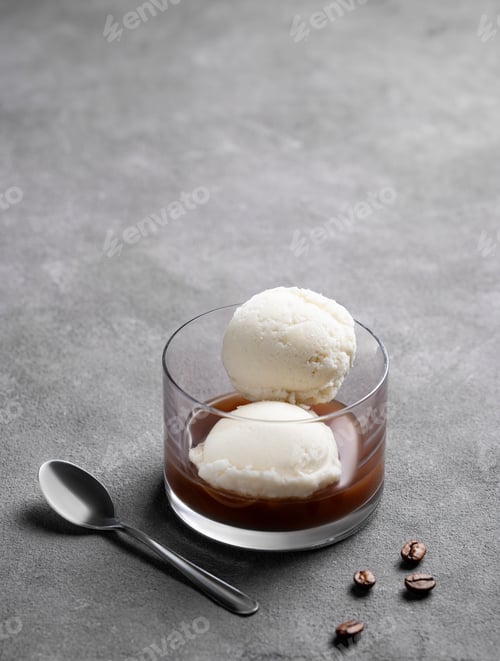 Preview: Affogato coffee with vanilla ice cream scoops and espresso in a glass on a dark background