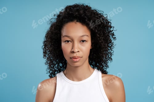Preview: Young African American woman posing in studio looking at camera