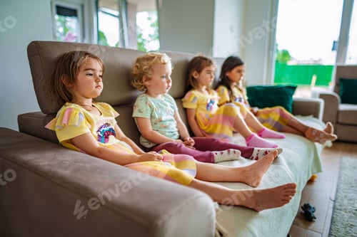 Preview: Children relax on a cozy couch in the sunny afternoon