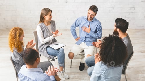 Preview: Happy people clapping at support group meeting