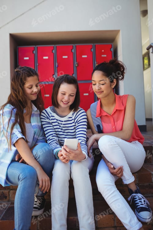 Preview: Students using mobile phone on staircase